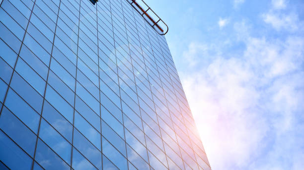 istock Modern office building with glass facade on a clear sky background. 1317168479