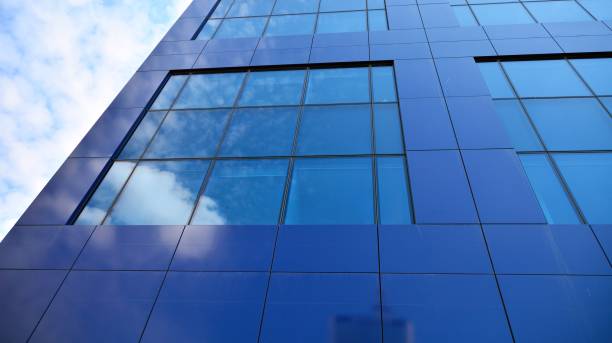 istock Modern office building with glass facade on a clear sky background. 1317168642