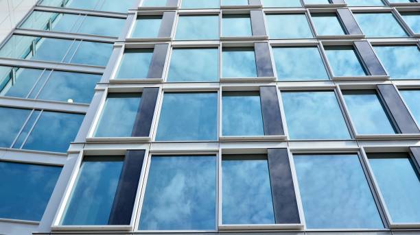 istock Modern office building with glass facade on a clear sky background. 1317168782