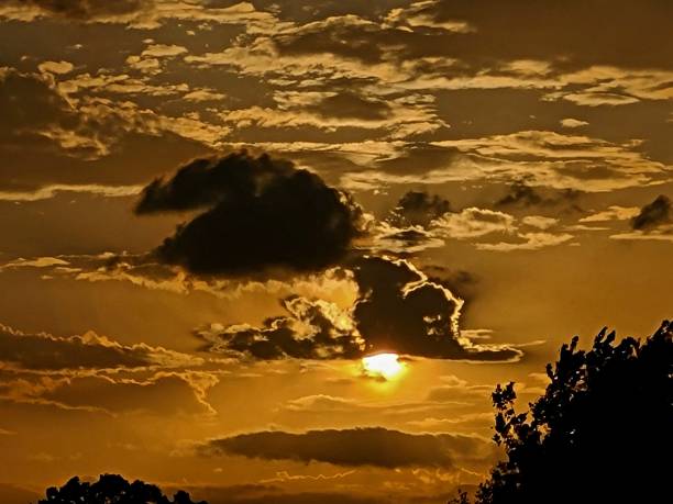 istock Sunset with highlighted clouds, reflecting off lake 1317175857