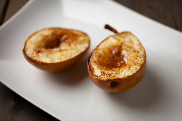 istock Baked pears with cinnamon and honey in a white plate close up 1317184563