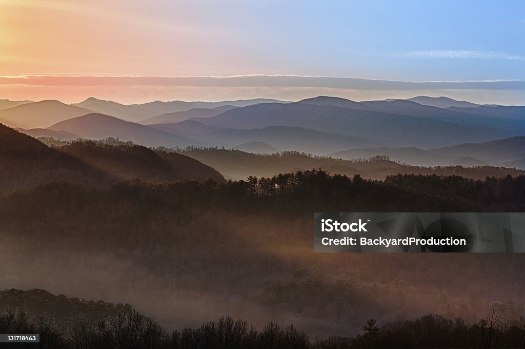 Sunrise over Smoky Mountains Sun rising over snowy mountains of Smokies in early spring with fog in valleys Great Smoky Mountains National Park Stock Photo
