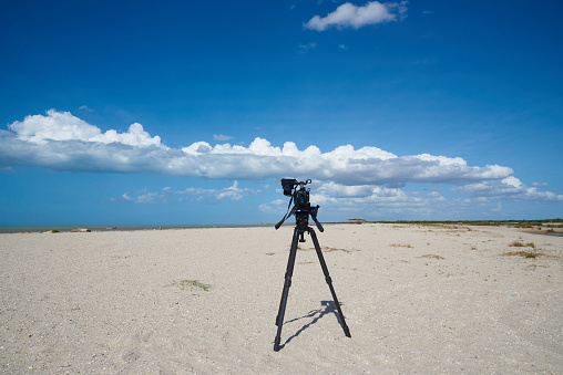 Camera on tripod prepared to capture images of a coast in the Guajira department. Colombia.