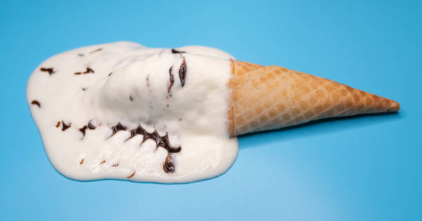 istock angle view vanilla and chocolate flavor ice cream cone in a melting process on a blue background 1317194749