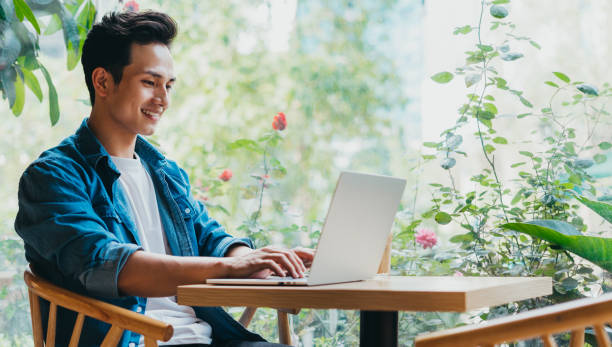 Man lifestyle Young Asian man working at coffee shop businessman happiness outdoors cheerful stock pictures, royalty-free photos & images