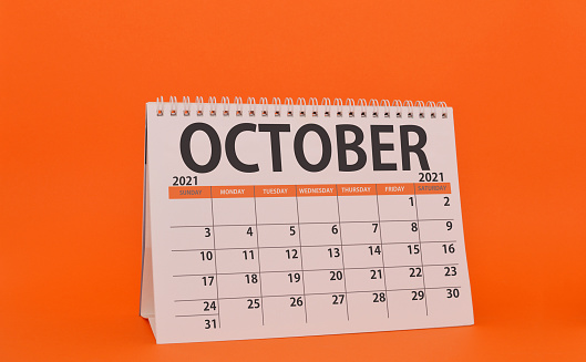Close up of October 2021 Calendar on orange background