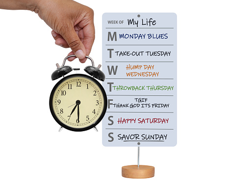 Week of my life white board (Monday Blues, Take-out Tuesday, Hump Day Wednesday, Throwback Thursday, TGIF, Happy Saturday, Savor Sunday) and hand holding clock
