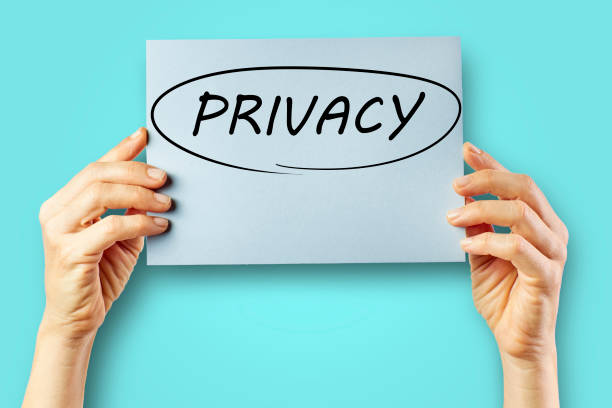 istock Woman's hands holding a cardboard with a circle and the word Privacy. 1317204024
