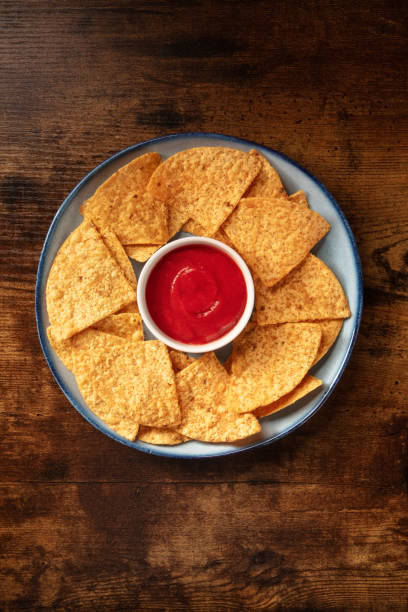 istock Nacho chips with a tomato salsa, served on a plate 1317206847