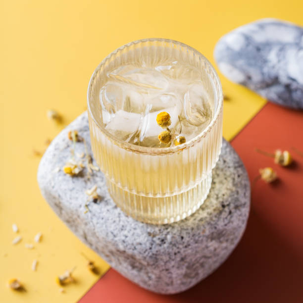 Hard seltzer cocktail with chamomile and ice Hard seltzer cocktail with chamomile and ice on a table. Summer refreshing beverage, drink soda water glass lemon stock pictures, royalty-free photos & images