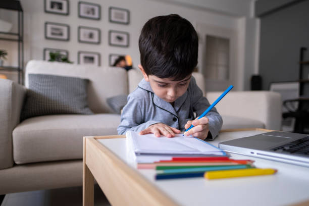 istock Little boy doing homework at home 1317208697