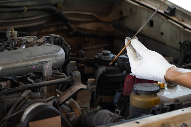 istock Auto mechanic checking the oil level in car engine,inspects engine water level dipstick,Check the dipstick in the car engine. 1317208714
