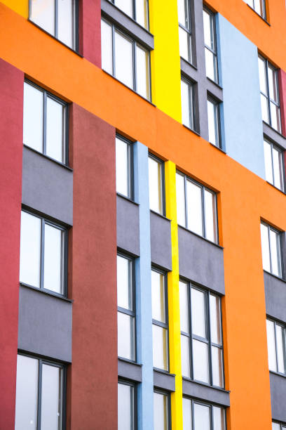 istock Modern building angle and windows. Multistory new multicolored apartment building. Stylish living block of flats. Bright juicy colors in the construction of buildings 1317210532