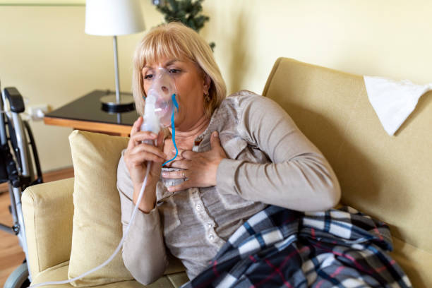 istock Ill Senior Woman With a Flu Virus and Using Inhaler. 1317211676