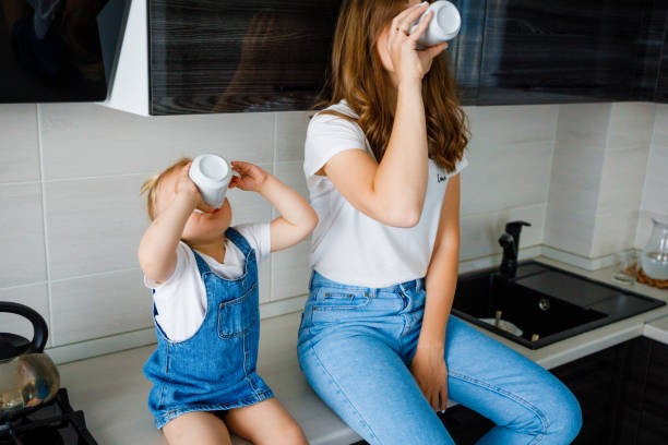 istock Mother is drinking tea in the kitchen with her little daughter. 1317216913