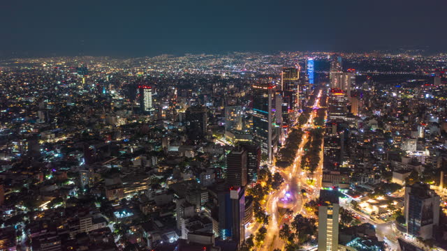 Beautiful Aerial Drone Hyperlapse view of urban modern Mexico City center with tall skyscrapers and flashing City lights at night, Hyper Lapse of City movement