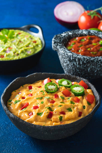istock Cheddar cheese dip with Nacho chips and assorted Mexican Dip as guacamole, pico de gallo 1317218916