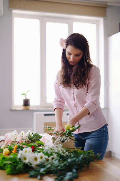 istock Beautiful florist arranging a flower composition 1317218988