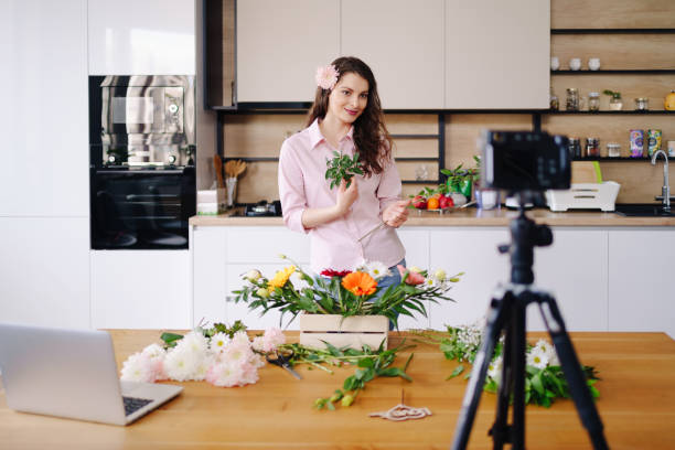 istock Woman using camera to stream home online tutorial on her blog 1317219519