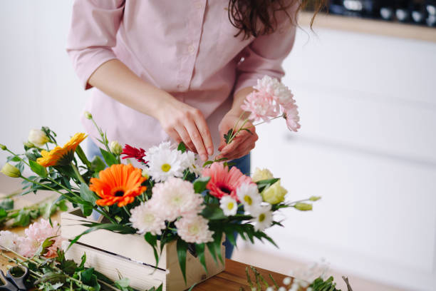 istock Beautiful florist hands arranging a flower composition 1317219527