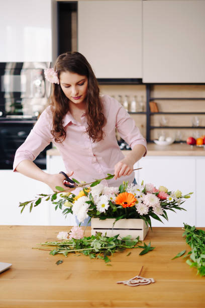 istock Beautiful florist arranging a flower composition 1317219576