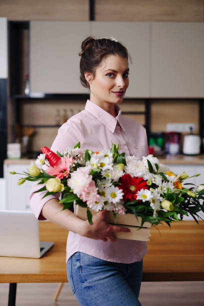 istock Portrait smiling woman with a beautiful flower composition 1317219663