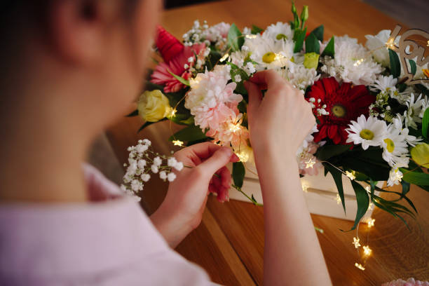 istock Beautiful florist arranging a flower composition 1317219773