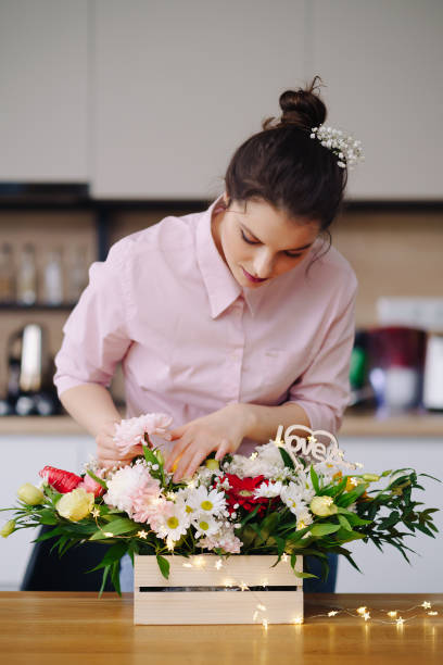 istock Beautiful florist arranging a flower composition 1317219810