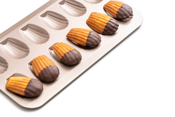 Madeleines Homemade and melted chocolate in a mold isolated on white