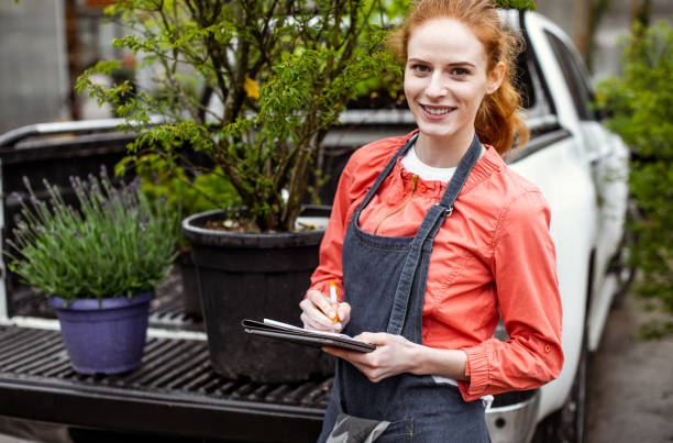 istock Garden center worker transporting plants 1317221419