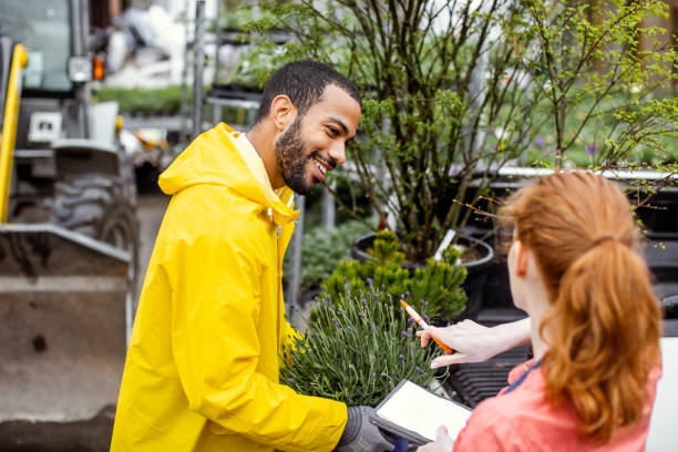 istock Garden center worker transporting plants 1317221528