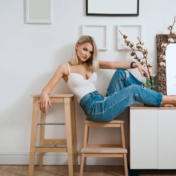 Blonde woman portrait sit in modern home interior stock photo