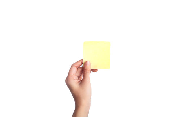 woman hand holding a yellow notepaper isolated on a white