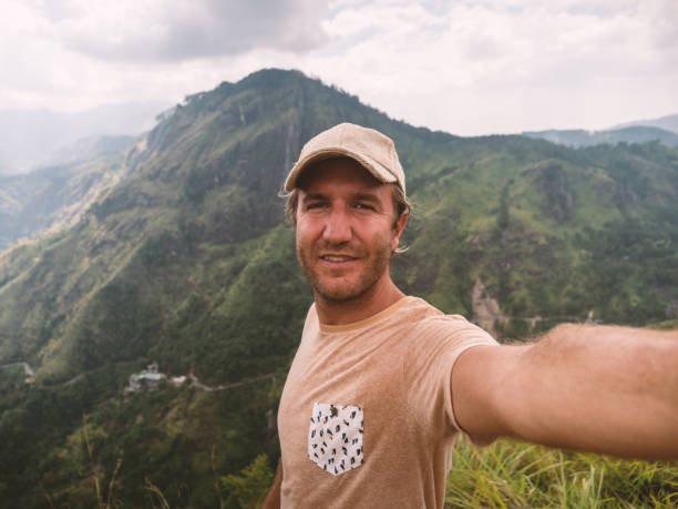 istock Man takes selfie photo on mountain top 1317224397