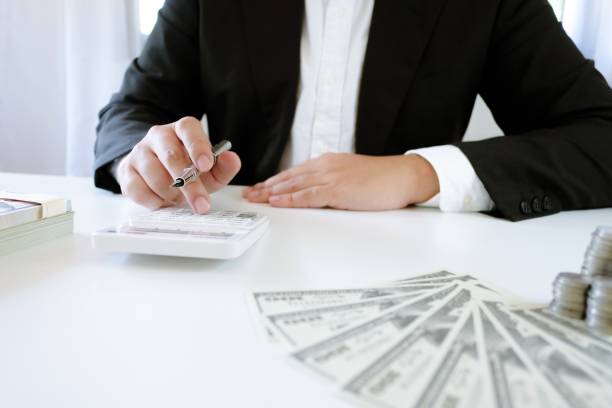 istock Accountant Working man uses calculator with Spreadsheet document, information financial concept. 1317225208