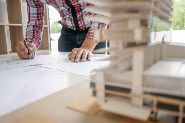istock Architecture drawing on architectural project business architecture building construction Colleagues interior designer Corporate. Planning Design on blueprint Teamwork with compasses. 1317225482
