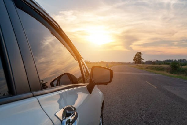 istock Sunset cloudy reflection on the glass white car 1317225772