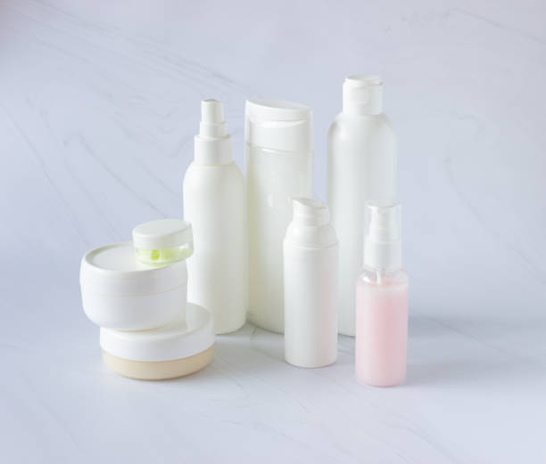 istock White bottles and cans for cosmetics on a light background. Clean, layout and template 1317227015