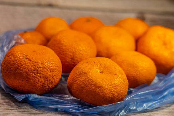 istock Tangerines lie in a package on the background 1317228106