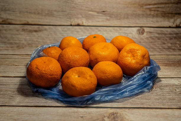istock Tangerines lie in a package on the background 1317228107