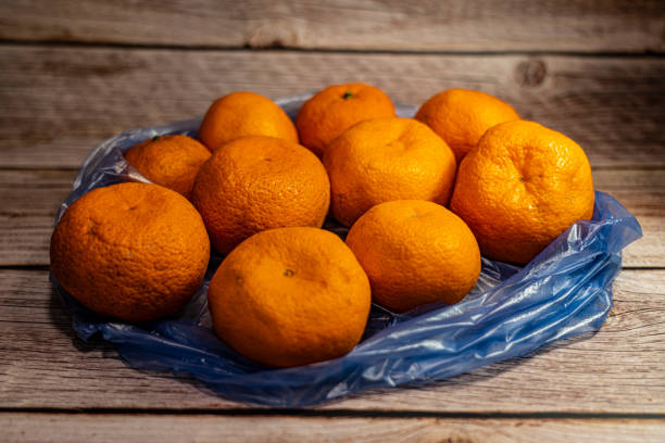 istock Tangerines lie in a package on the background 1317228108