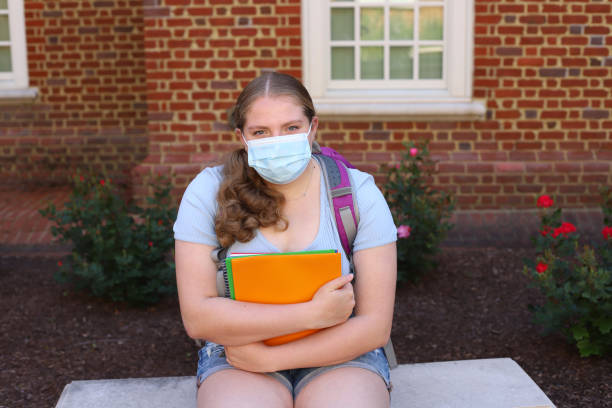 istock 14 year old girl read for back to school posing with her notebooks and backpack. 1317231608