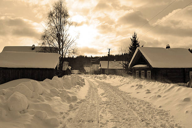 Winter scenery: road in snow-covered Russian village. Sepia.
