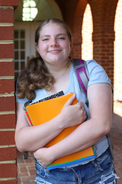 istock 14 year old girl read for back to school posing with her notebooks and backpack. 1317232182