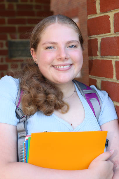 istock 14 year old girl read for back to school posing with her notebooks and backpack. 1317233258