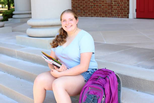 istock 14 year old girl read for back to school posing with her notebooks and backpack. 1317234491
