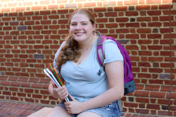 istock 14 year old girl read for back to school posing with her notebooks and backpack. 1317234808