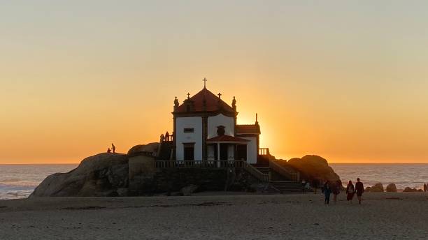 istock Sunset behind church at the beach 1317235195