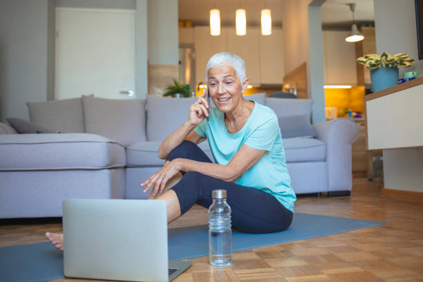 istock Senior woman using smartphone at home after exercise. 1317235576