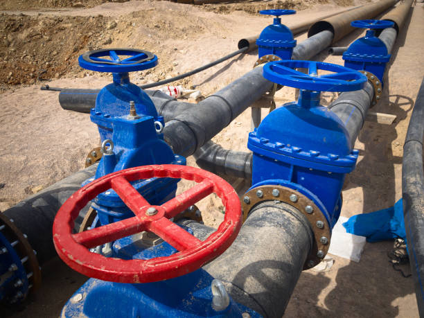istock Valves on pipeline in ground. Pipe valves in trench 1317236384